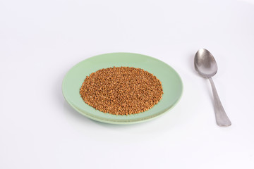 buckwheat groats on a plate isolated on white background