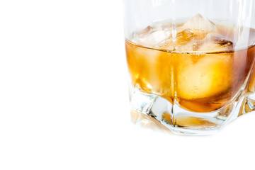 Whiskey with ice close-up in a glass isolated on a white background