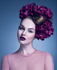 Girl with a creative hairstyle and blossoming flowers.