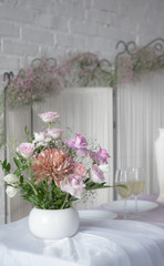 The decor of roses and baby's breath on a white brick wall background