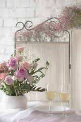 The decor of roses and baby's breath on a white brick wall background
