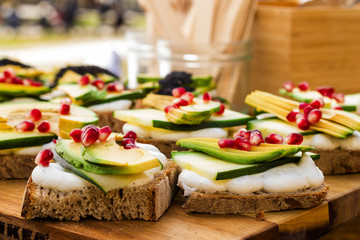 Avocado Sandwich with Feta cheese - sliced avocado and Feta cheese on bread with arugula leaves,...