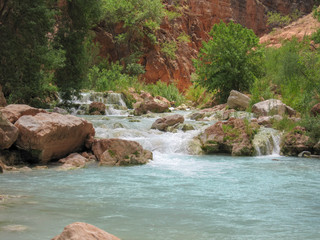 Naklejka na ściany i meble Serene green blue river running in lush desert valley