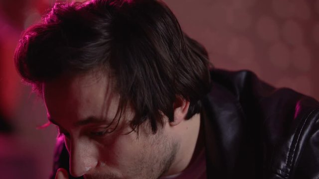 Young guy snorting heroin at party and looking at camera, drug addict needs help