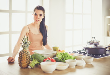 Young with with basket of fresh vegetables in the kitchen