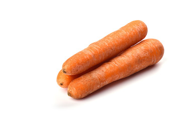 Three washed carrots isolated on white background. Copy space.