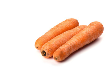 Three washed carrots isolated on white background. Copy space.