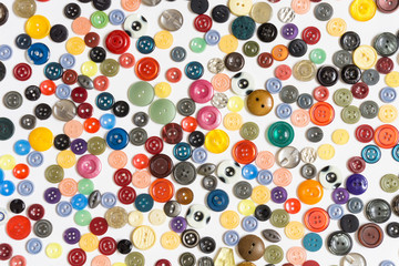 background - multicolored buttons on a white surface