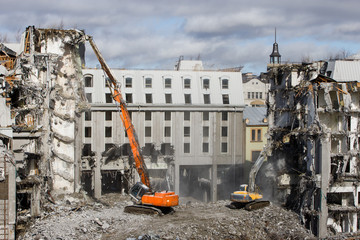 Building of the former hotel demolition for new construction, using a special hydraulic...