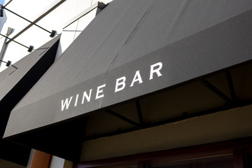 A standard or common wine bar sign on a black awning