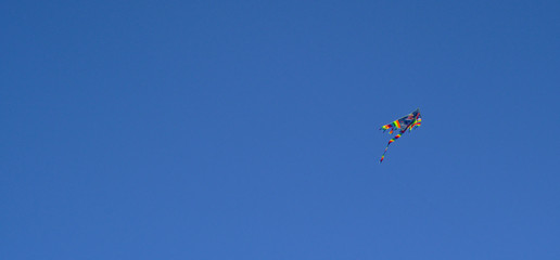 Obraz na płótnie Canvas Kite flying, deep blue sky with some clouds. Clean Monday holiday. Athens, Greece 2019.