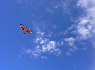 Fototapeta na wymiar Kite flying, deep blue sky with some clouds. Clean Monday holiday. Athens, Greece 2019.