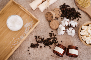 Fototapeta na wymiar Top view spa and wellness setting with natural bath salt, soap, candles, towels, cotton flowers and coffee beans for massage for perfect healthy body and skin. Beauty luxury spa concept. Copyspace