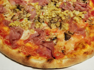 Pizza capricciosa on a white background
