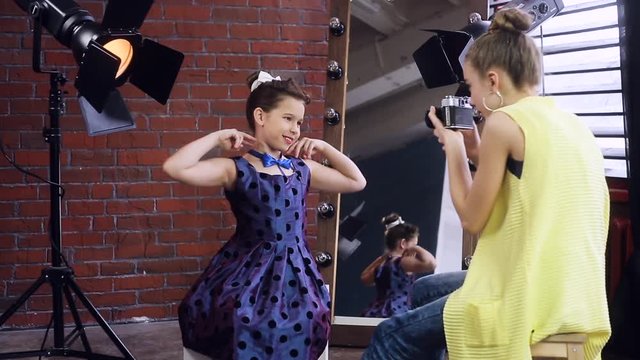 Child photographer holds a photo shoot with a young model