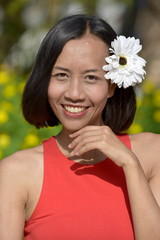 Smiling Minority Female With A Flower