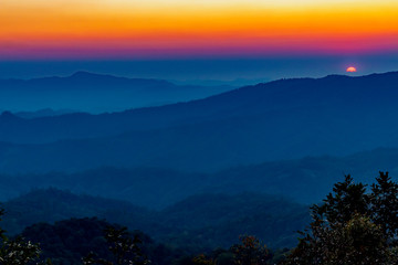 Fototapeta na wymiar beautiful orange sky with mountain view during sunset