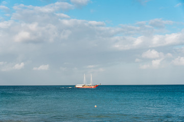 Old sailing ship in the sea of Aruba island near the beach on a sunny day. Netherlands Antilles