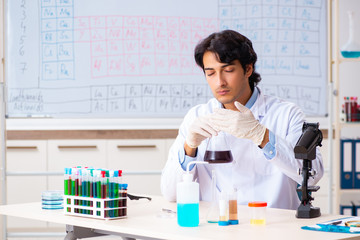 Young chemist working in the lab