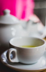 Cup of tea with teapot, cup of green tea.