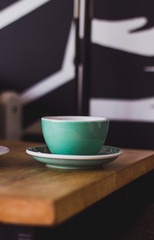 Black coffee in blue cup on wooden background, filter coffee. 