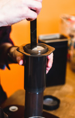 Fototapeta na wymiar Step by step aero press coffee preparation. Professional coffee brewing cafe shop.