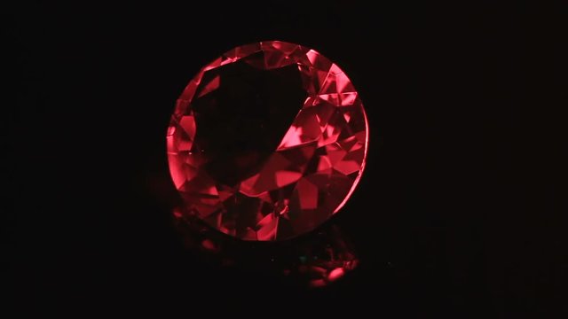 Huge Red Ruby Rotating And Shining In The Dark