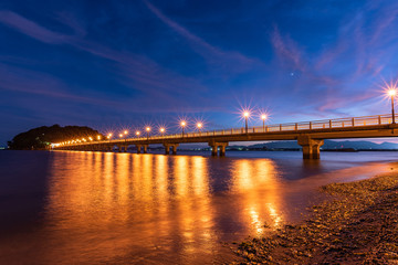 Fototapeta na wymiar Light up of the bridge to the island at sunset. Aichi, Japan