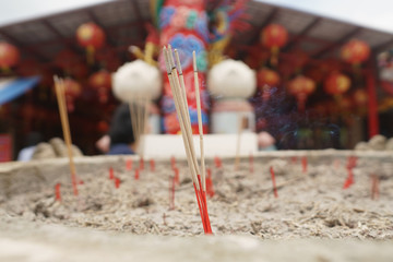 Incense stick in sand pot at chinese temple