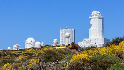 Taking pictures surrounded by flowers at the astronomical observatory on a sunny day