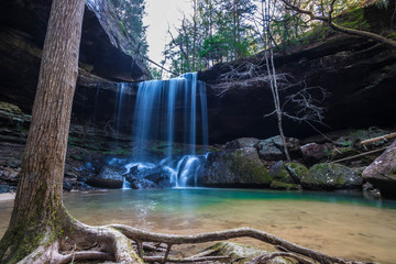 The beautiful blue waters Sougahoagdee falls in Bankhead National Forest