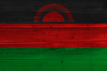 Malawi flag painted on old wood plank