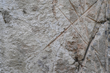Cracks in brown concrete wall textured