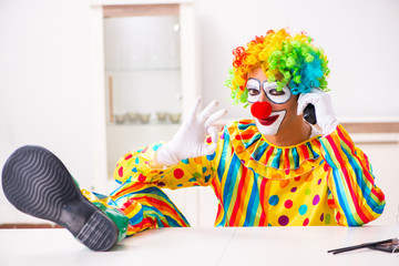Male clown preparing for perfomance at home