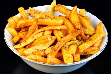 French fries popular food and snack - is a piece of potatoes, fried in a large amount of strongly...