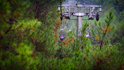 The cable car transport across the hills mountain forest and nature.