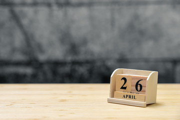 April 26 wooden calendar on vintage wood abstract background. using as background Universal day concept with copy space for your text or design.