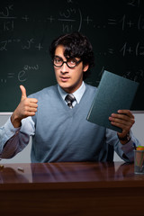 Young math teacher in front of chalkboard