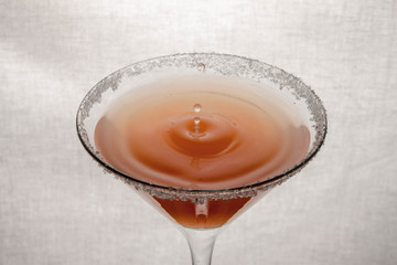  glass goblet on white background with  liquid splashing