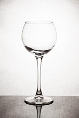  glass goblet on white background with  liquid splashing
