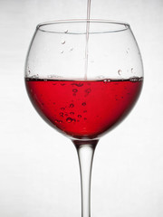  glass goblet on white background with  liquid splashing