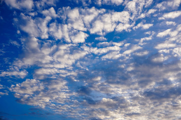 Closeup background and texture of bright blue sky and cotton clouds with sun lights on afternoon summer.