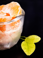 Ripe tangerine helmets with leaves