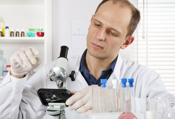 Scientist working with a microscope