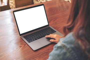 Mockup image of a woman using and touching on laptop touchpad with blank white desktop screen on...