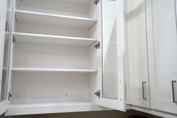 close up on white kitchen cabinet with door open