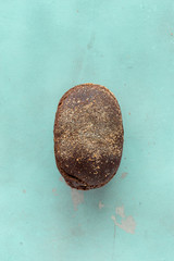 Whole loaf rye bread crisp stone background top view