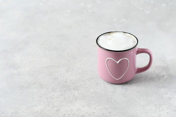 one pink cup cappuccino. cups with  heart, gray background. concept of romance and loneliness, waiting for love.   selective focus and copy space. love card, romantic background