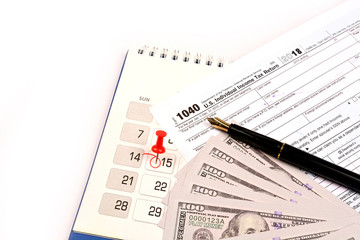 Red pushpin in calendar on 15th April for US tax day