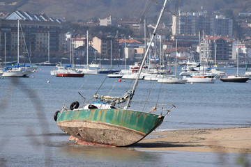 boat in the port of France abandoned at low tide